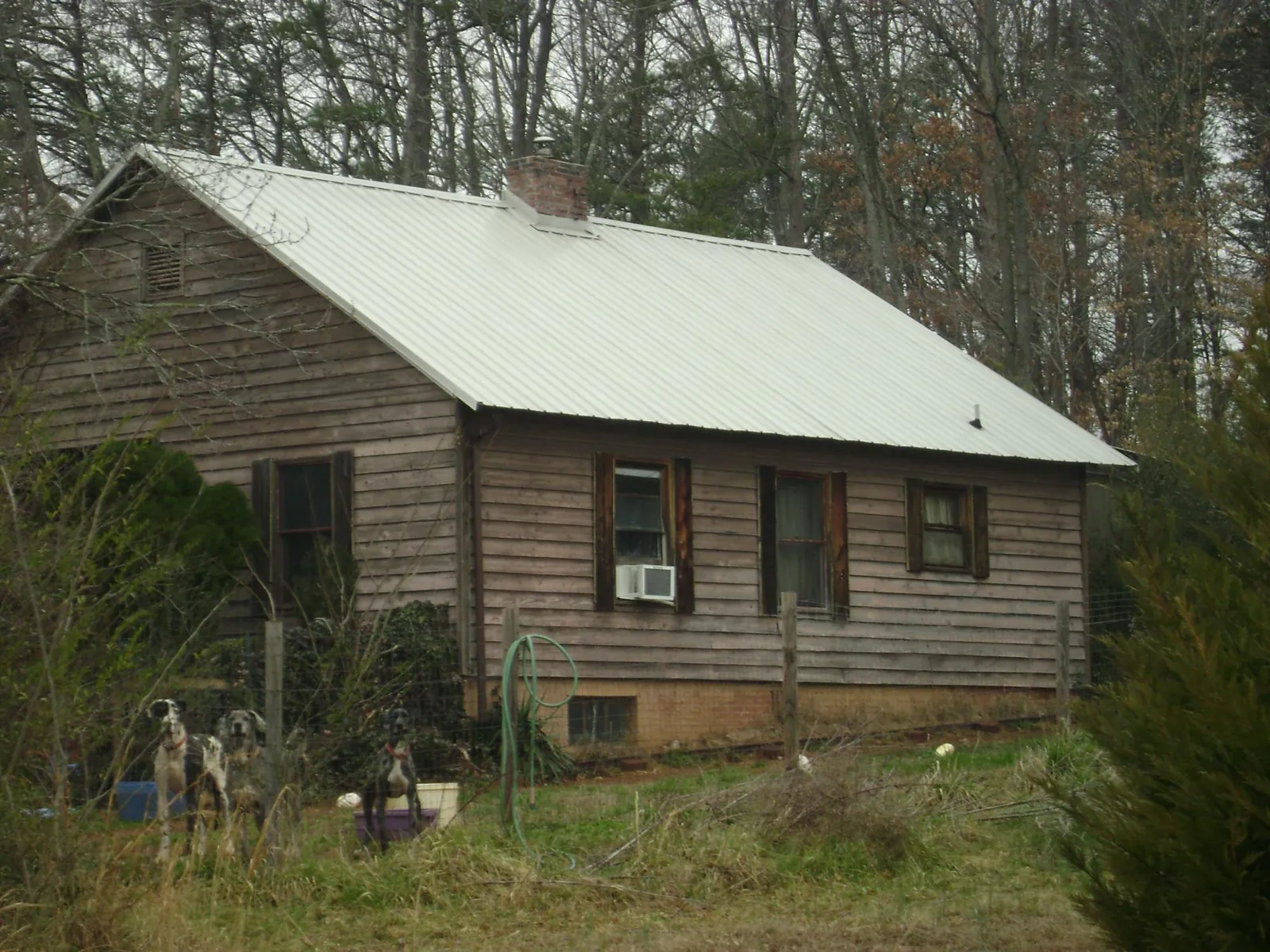 White metal roof on an old wood sided farmhouse, from a Metal Roof Installation job in Robinson